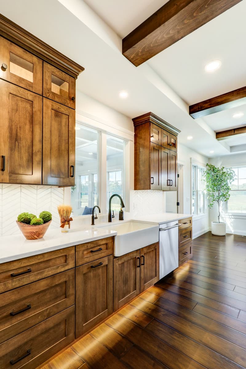 A farmhouse sink in walnut cabinetry with under cabinet lighting